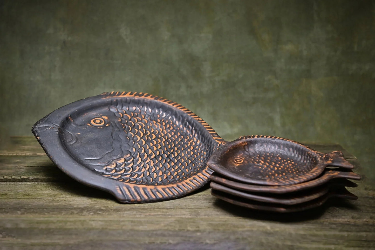 Handmade clay fish-shaped plates with textured scales, artisan-crafted homeware for rustic décor