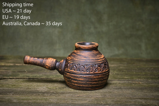 Handmade clay pot with carved floral design, rustic brown glaze, artisan-crafted homeware for boho décor
