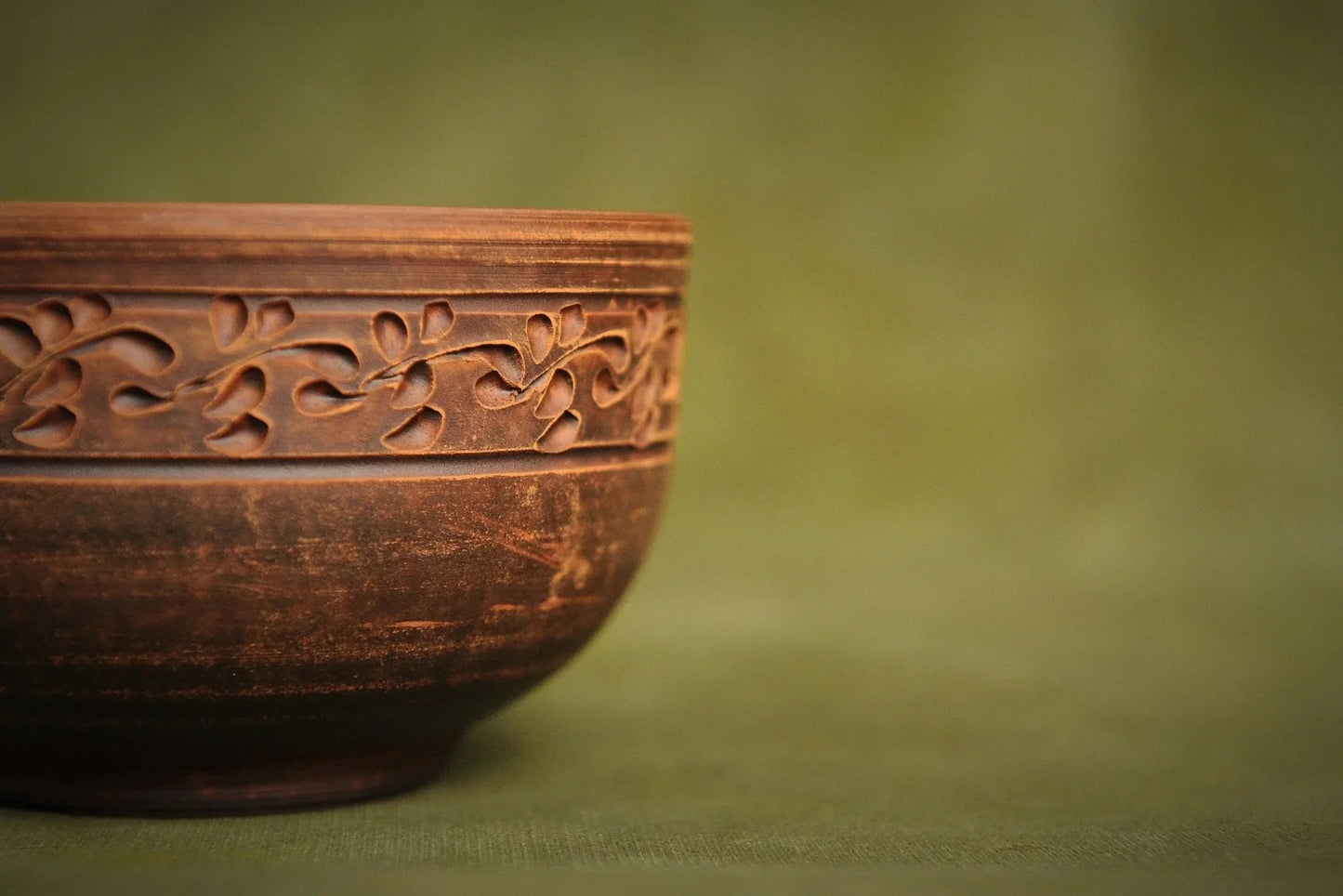 Handmade Ukrainian deep red clay bowl with carved floral pattern, artisan pottery homeware