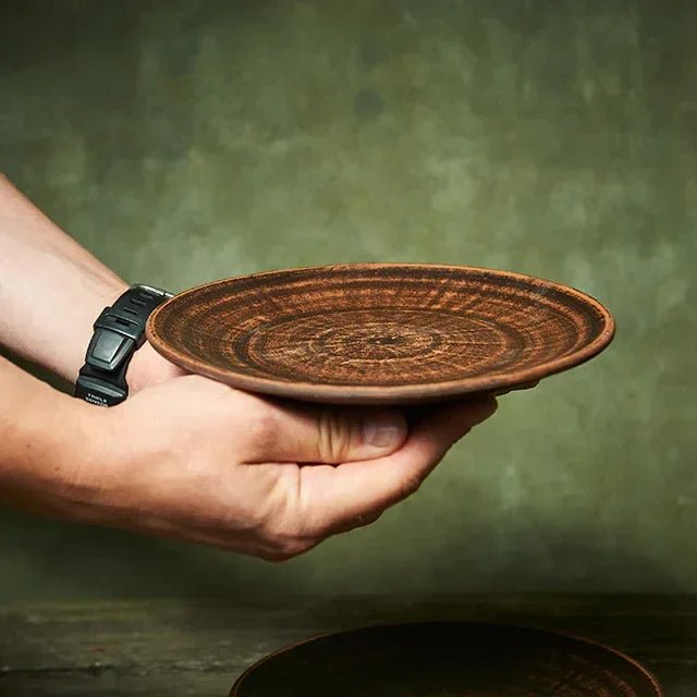 Hand holding a rustic handmade ceramic plate, artisan clay homeware, clayproductsshop