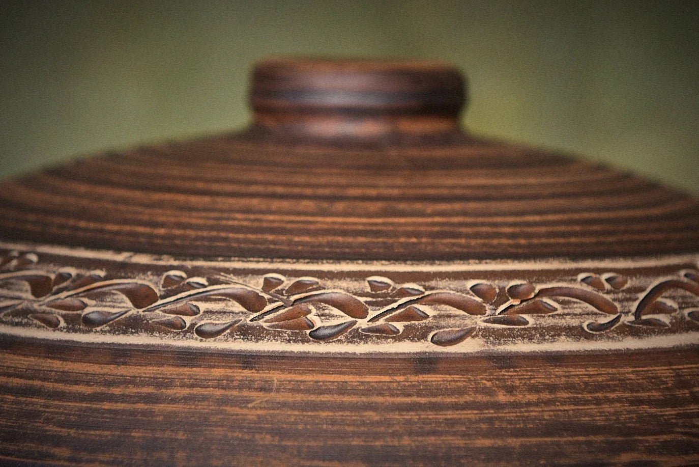 Handmade clay pot lid with etched floral pattern, rustic ceramic kitchenware