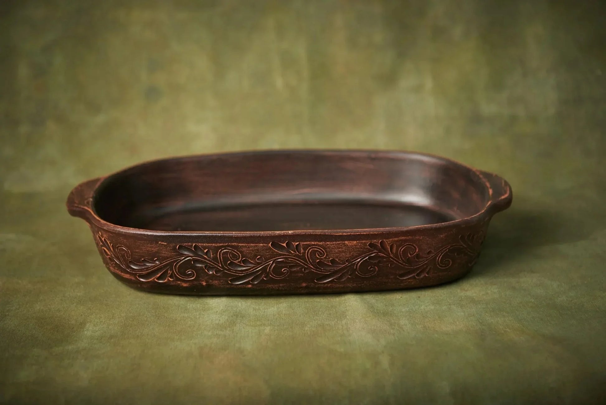 Handmade ceramic baking tray with carved floral detailing, artisan clay homeware dish