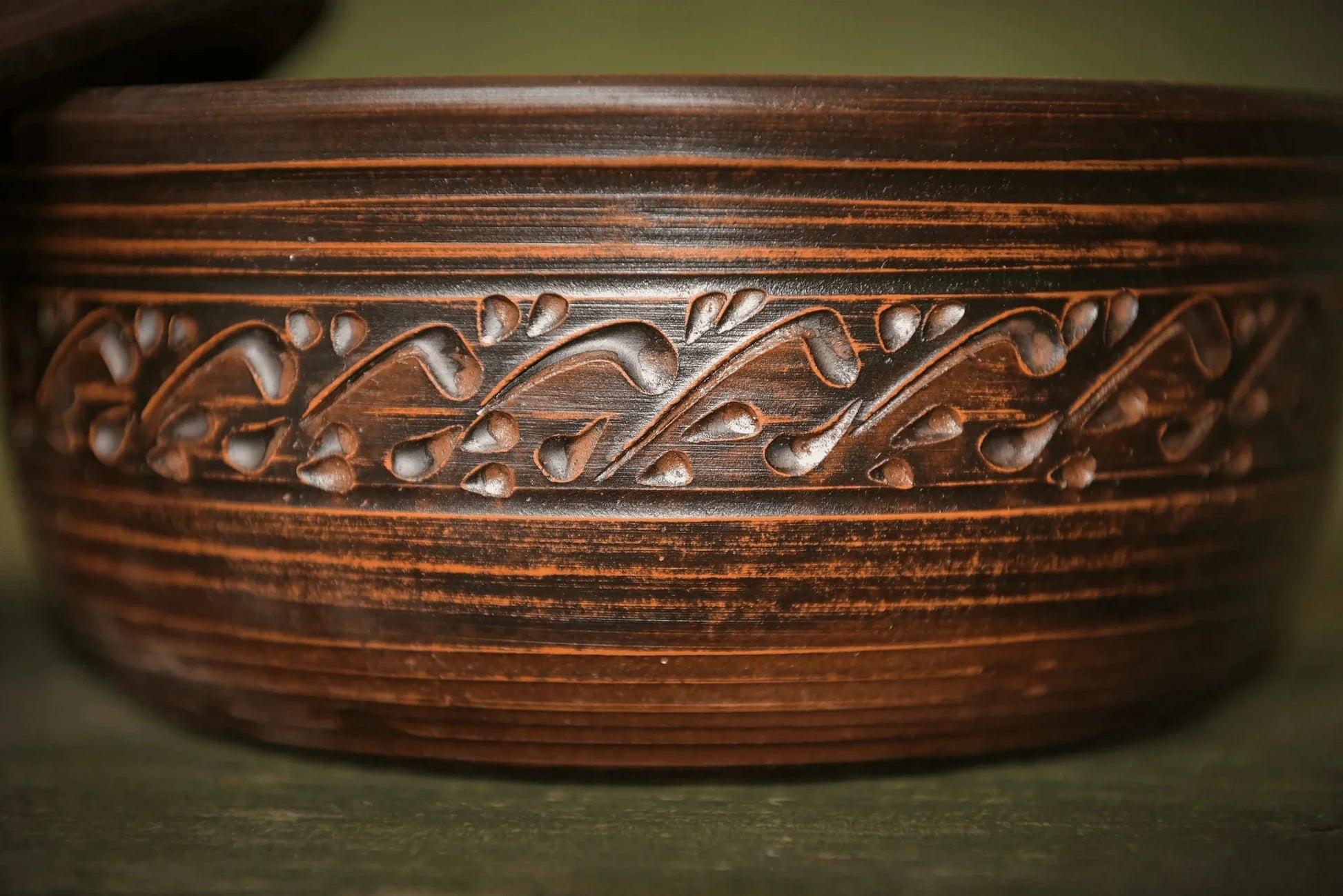 Handmade brown ceramic bread pot with lid, featuring decorative leaf pattern, artisan homeware