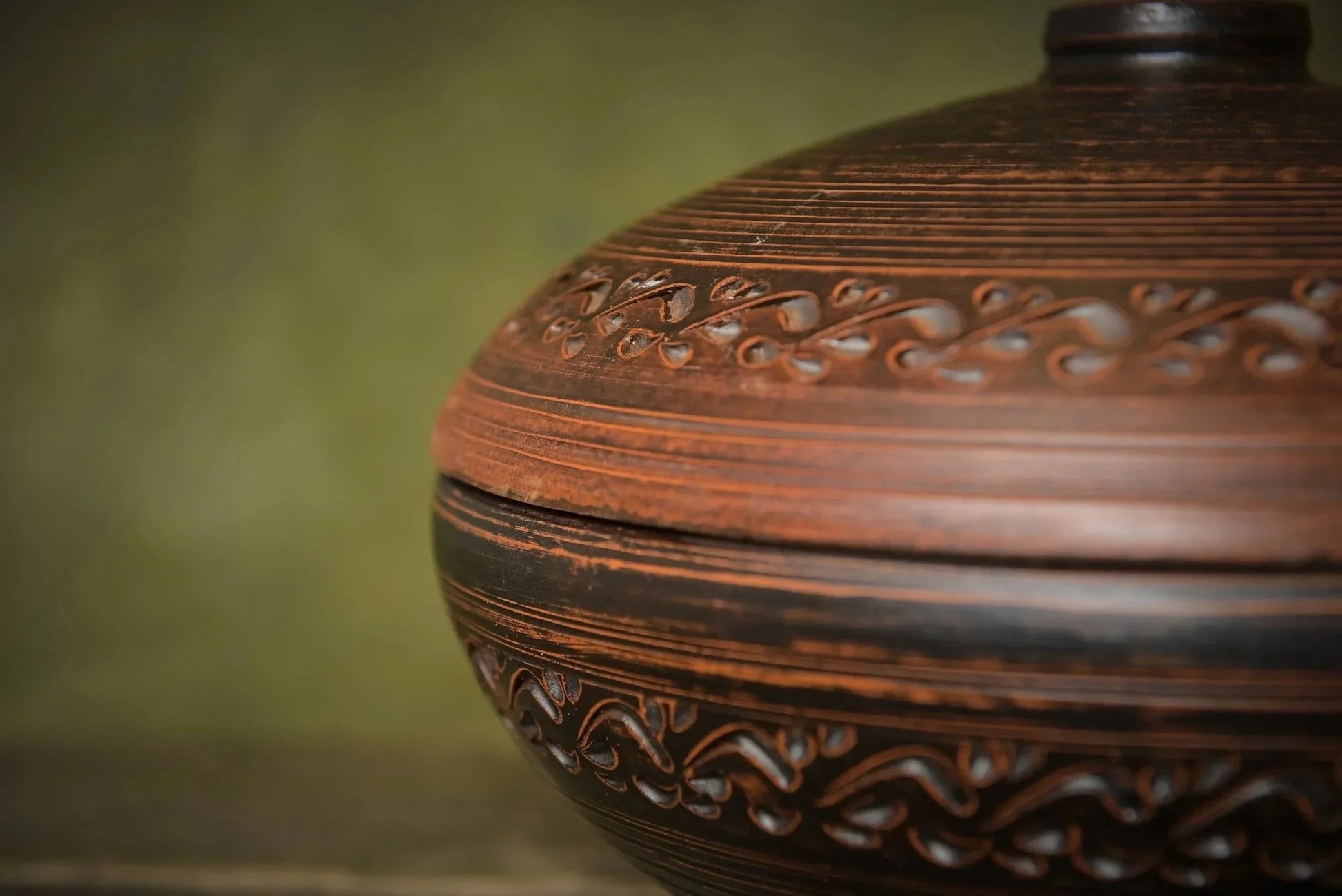 Handmade clay cooking pot with lid, detailed carved pattern, rustic homeware