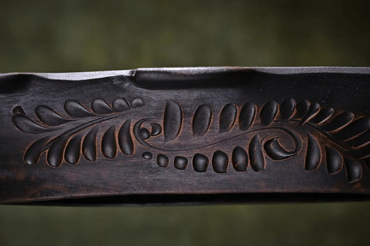 Handmade dark clay pottery plate with carved leaf pattern, artisan home decor