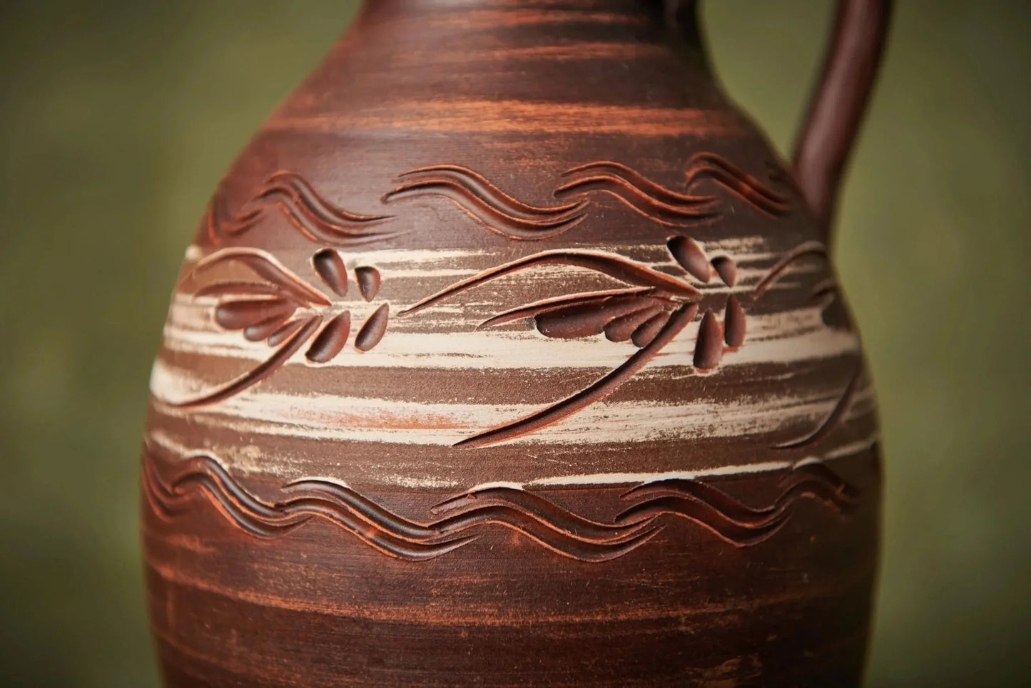Handmade clay pitcher with carved floral pattern, artisan ceramic homeware from clayproductsshop