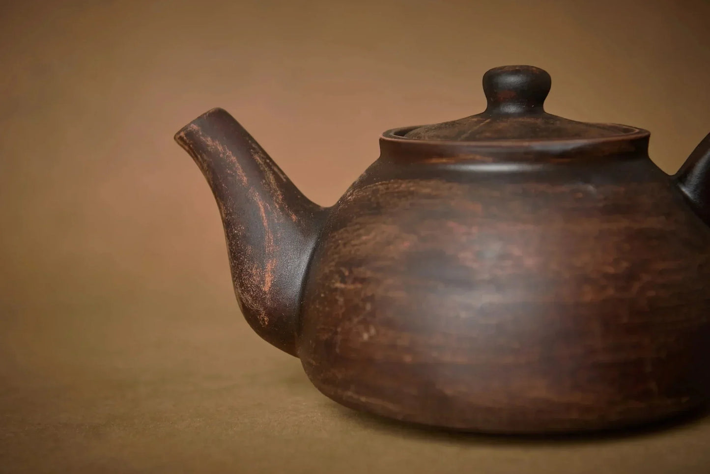 Handmade ceramic teapot with rustic finish, artisan pottery, brown clay teaware
