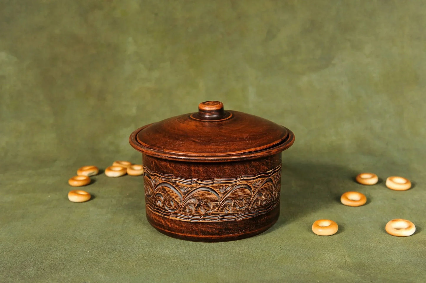 Handmade clay bread baking pan with lid and ornate patterns, rustic kitchen decor.