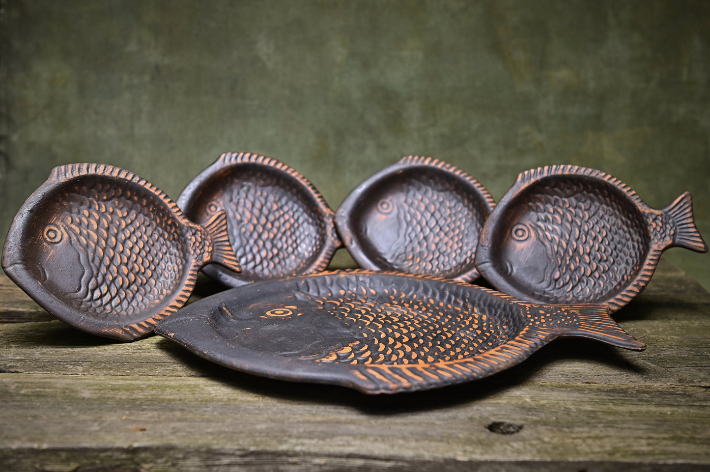 Handmade clay fish-shaped plates on rustic wood, artisan homeware from clayproductsshop