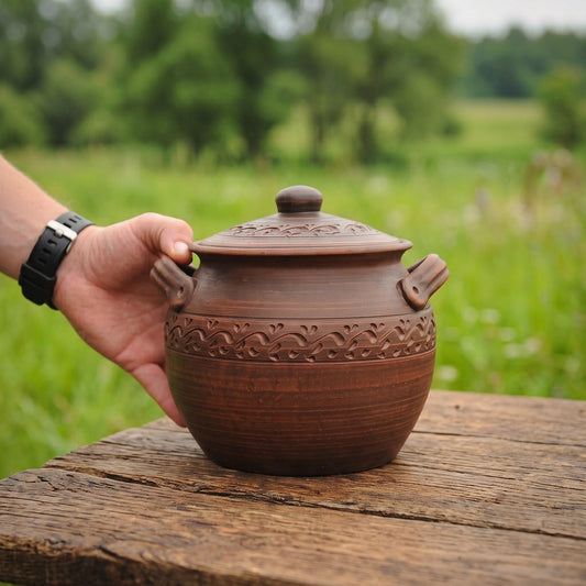 Handmade clay pot with carved floral design, perfect for rustic home decor