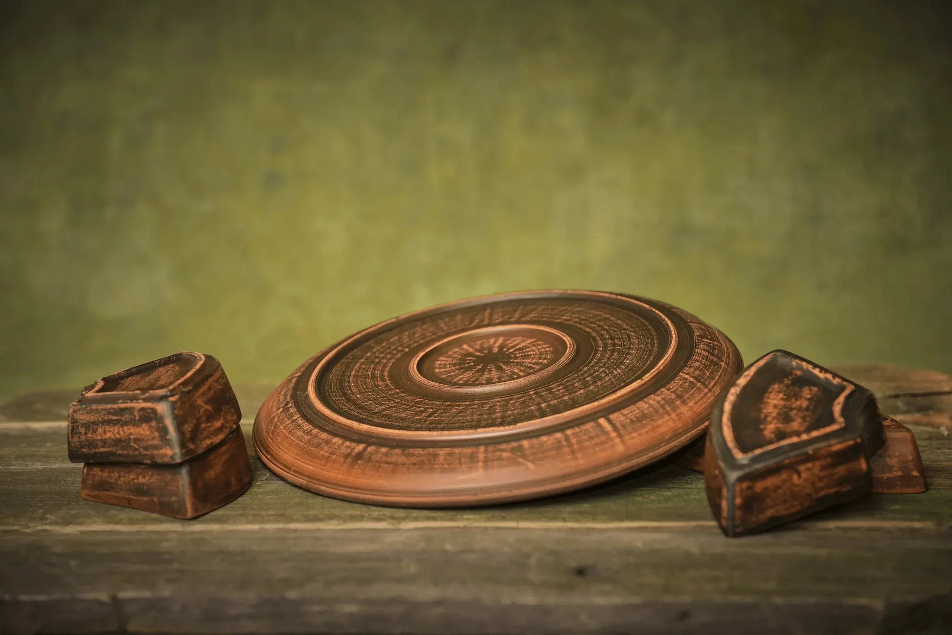 Handmade ceramic serving plate and clay bowls on rustic wood, artisan homeware décor