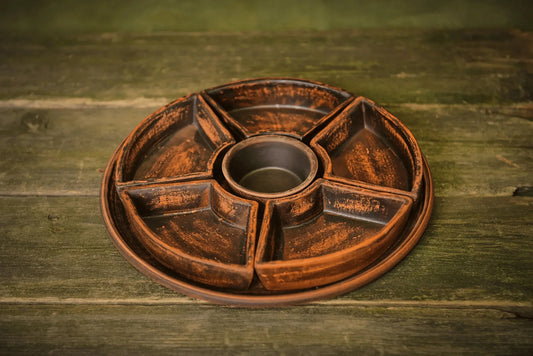 Handmade ceramic serving tray with five clay sections on rustic wooden table