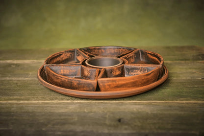 Handmade ceramic serving tray with sectional bowls, rustic finish, on wooden surface