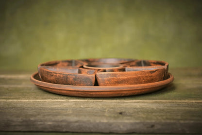 Handmade ceramic serving tray with matching clay bowls on rustic wooden surface