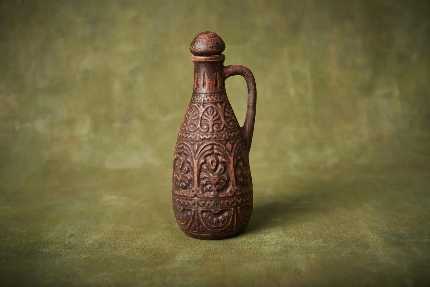 Handmade small ceramic clay pitcher jug with lid, intricate floral pattern, rustic decor