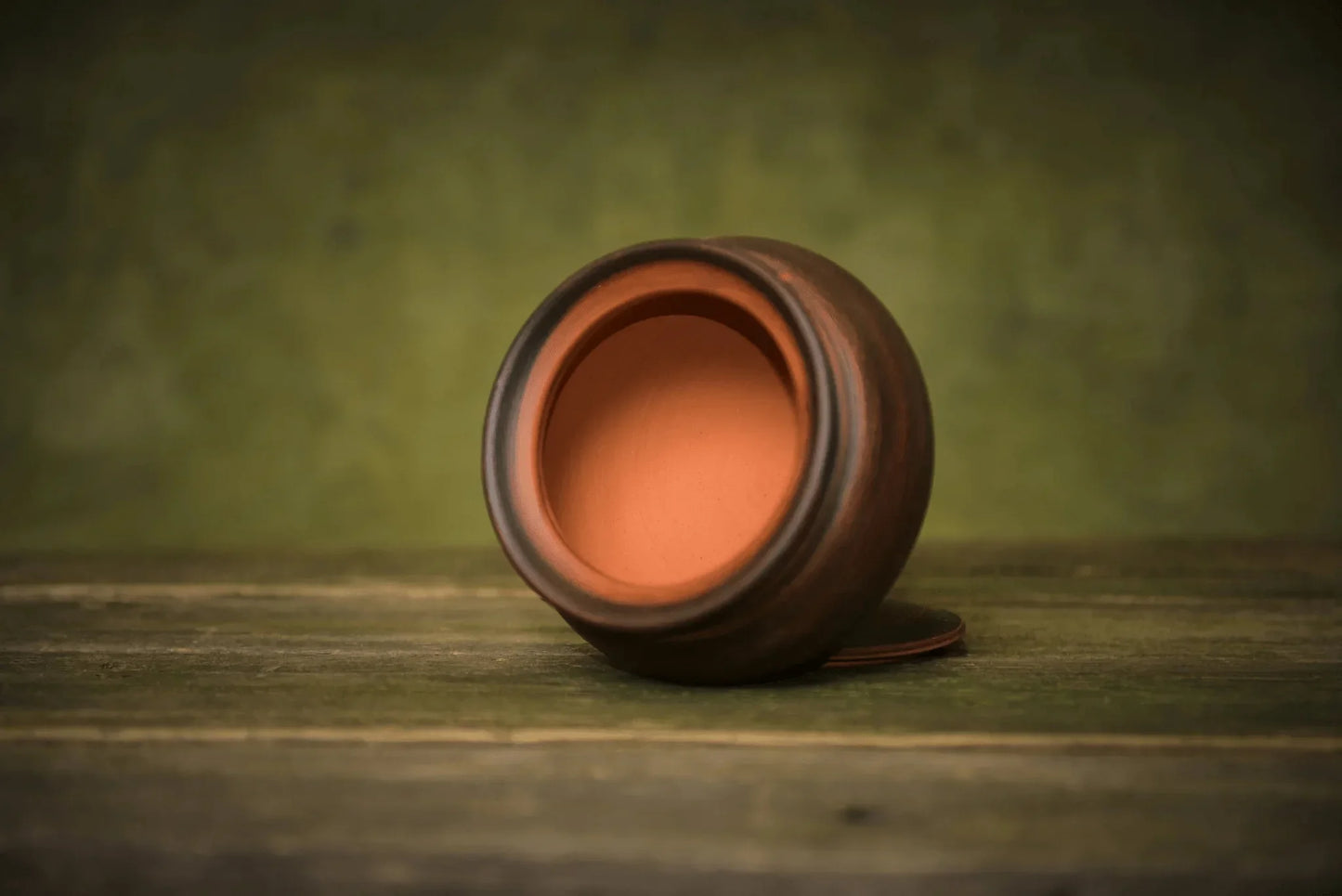 Handmade ceramic sugar bowl with lid on rustic wooden surface, artisan homeware