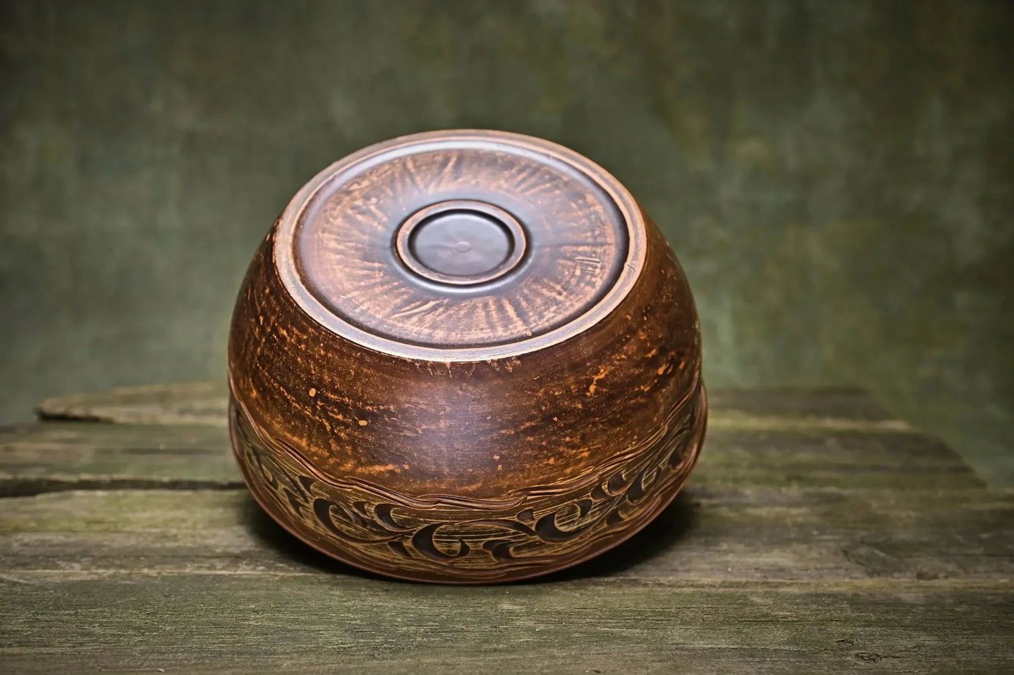 Handmade Ukrainian ceramic pot with lid, rustic brown glaze, artisan pottery on wood surface