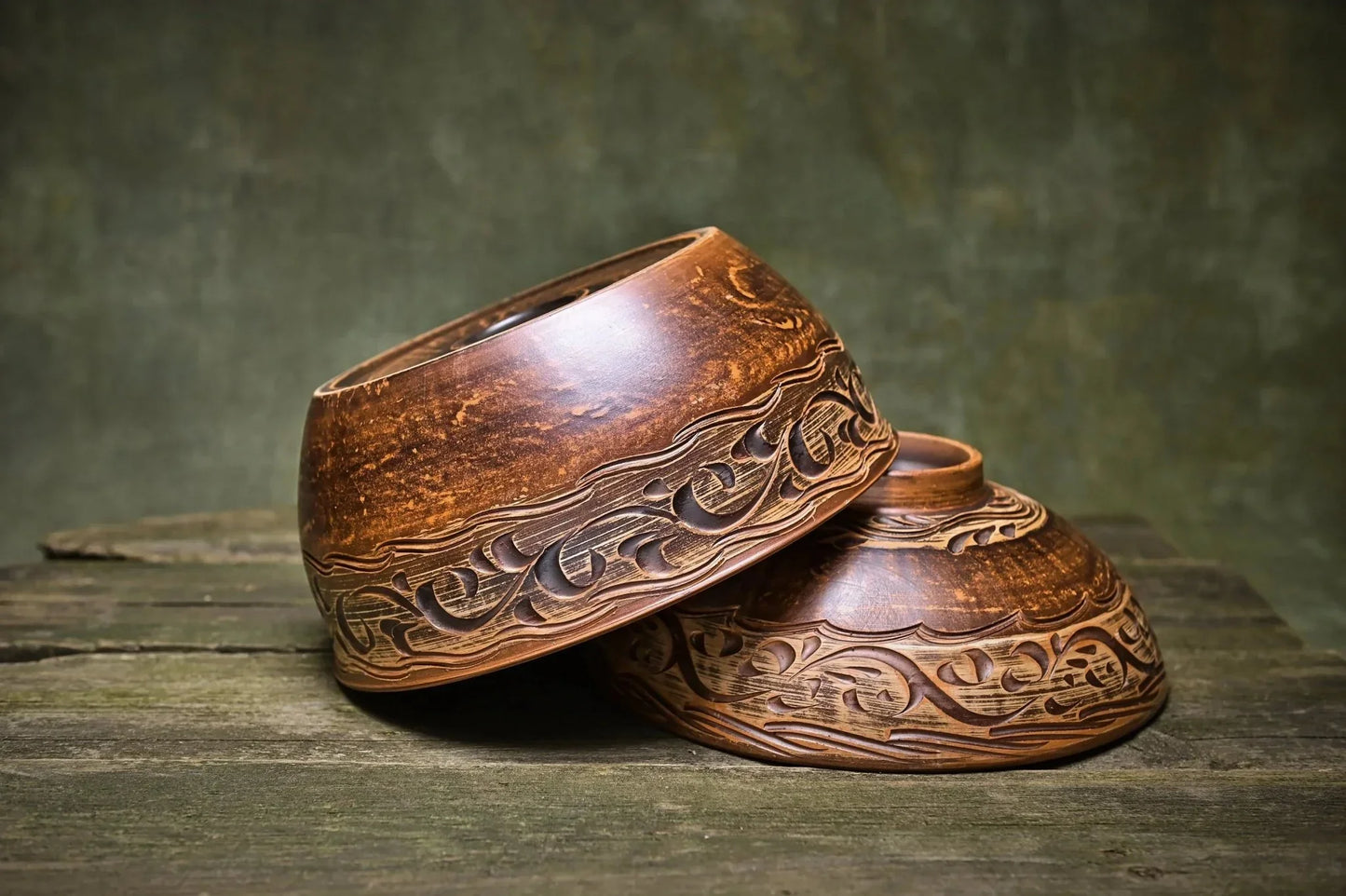 Handmade Ukrainian ceramic bowls with lid, rustic carved clay kitchenware on wooden table