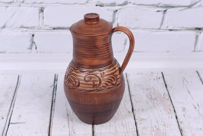Handmade clay jug with lid and handle, rustic ceramic vessel from clayproductsshop