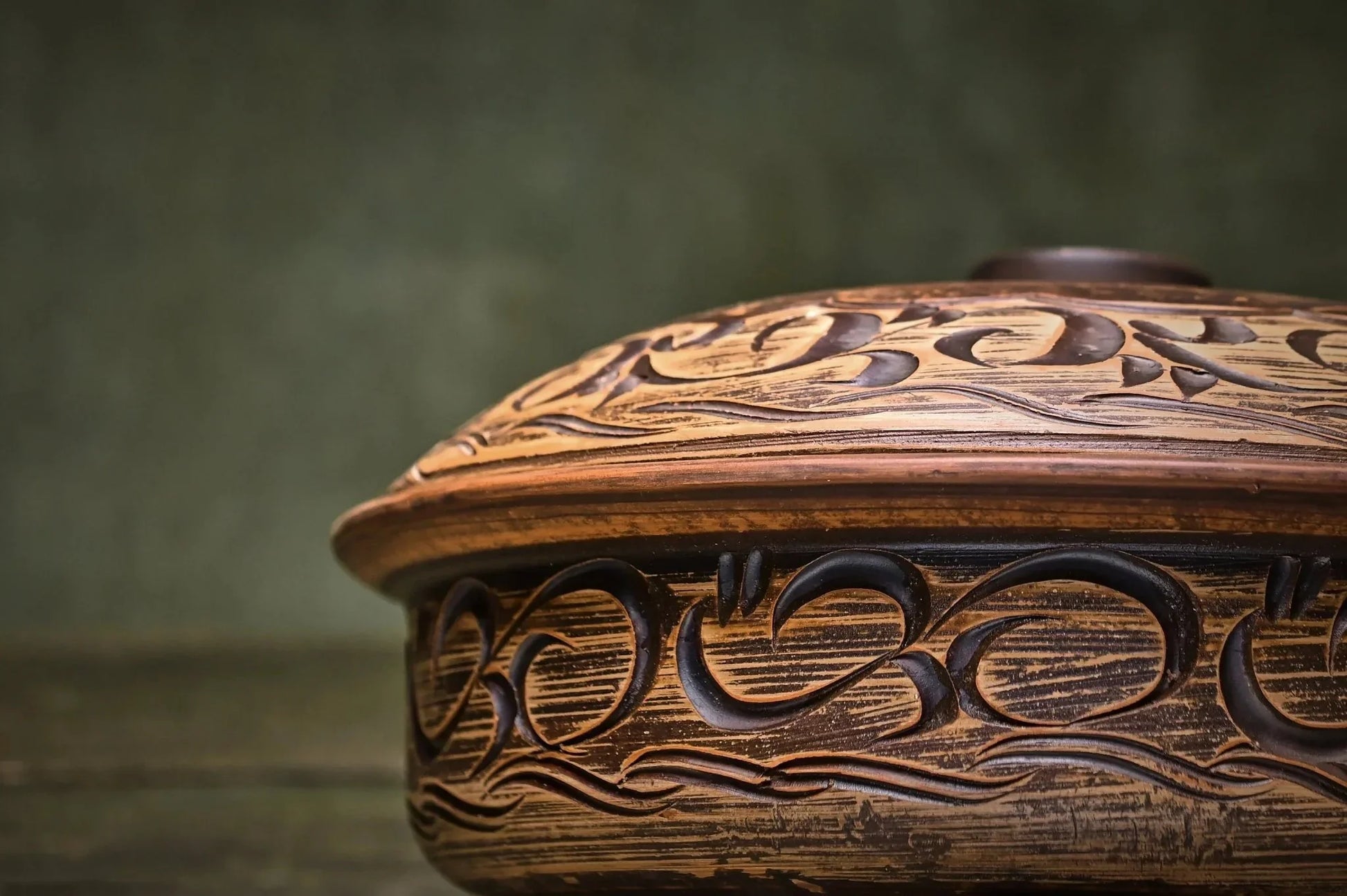 Handmade ceramic baking pot with intricate clay carving, artisan cookware from clayproductsshop