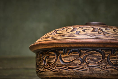 Handmade ceramic baking pot with intricate clay carving, artisan cookware from clayproductsshop