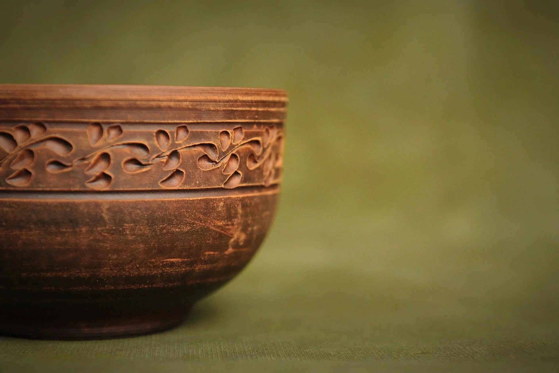 Handmade Ukrainian deep red clay bowl with carved floral pattern, artisan pottery homeware