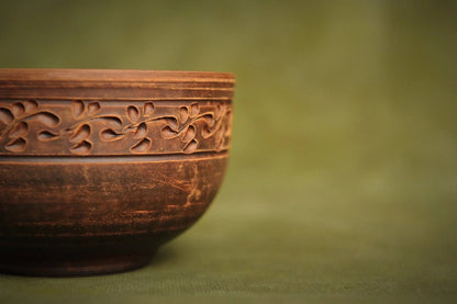 Handmade Ukrainian deep red clay bowl with carved floral pattern, artisan pottery homeware