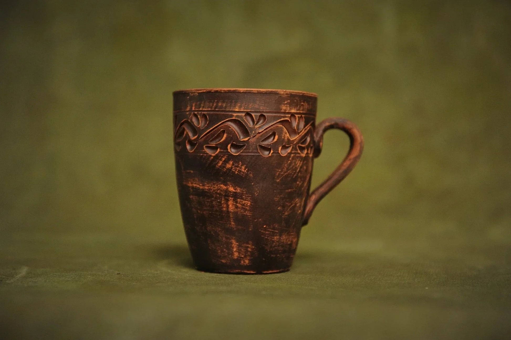 Handmade red clay ceramic cup with engraved ethnic pattern, artisan pottery homeware