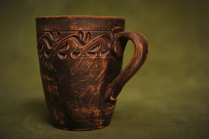 Handmade red clay ceramic cup with engraved ethnic pattern, rustic pottery homeware