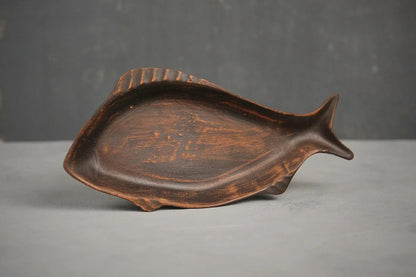 Handcrafted ceramic fish-shaped clay plate on a grey surface, artisan Ukrainian pottery