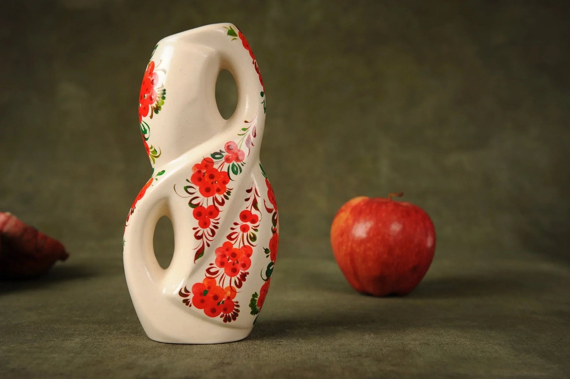 Handmade white ceramic flower vase with red floral design, unique home decor on table