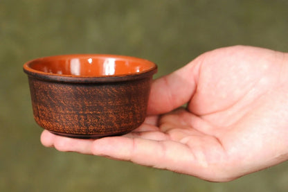 Hand holding small handcrafted brown ceramic clay bowl, artisan homeware by clayproductsshop