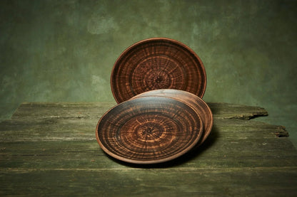 Handmade ceramic plate set of 3, dark clay pottery with rustic finish on wooden surface