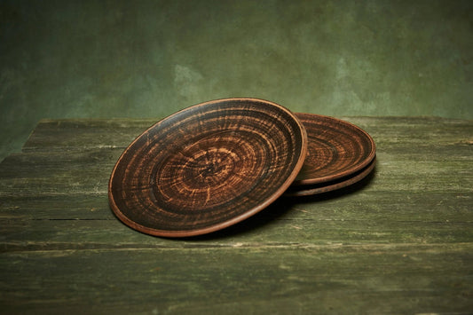 Handmade ceramic plates set of 3 with rustic brown finish, artisan clay dinnerware on wood table
