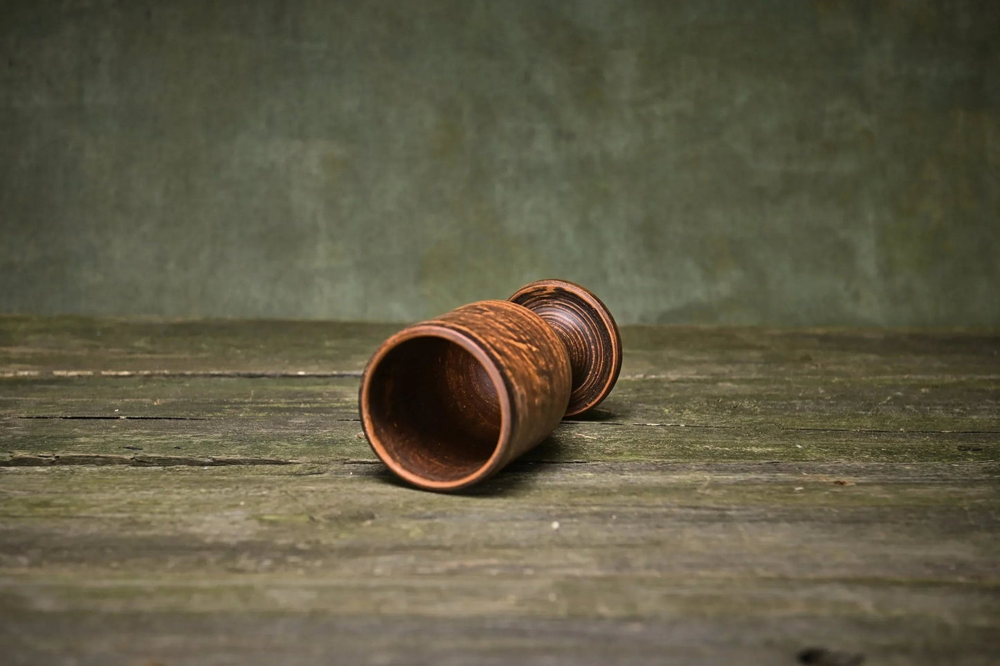 Handmade clay wine goblet with textured finish on rustic wood table, artisan pottery homeware