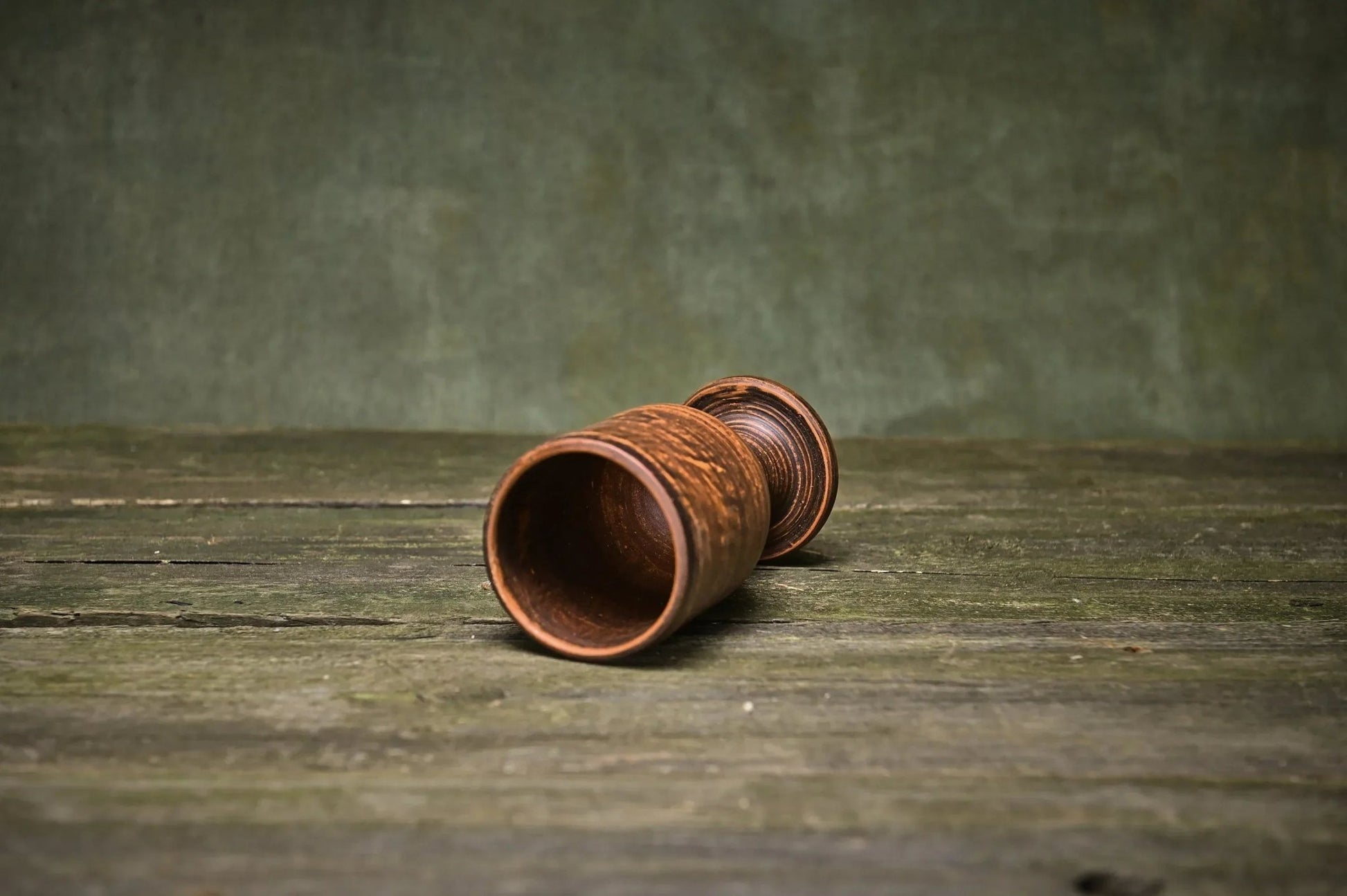 Handmade clay wine goblet with textured finish on rustic wood table, artisan pottery homeware