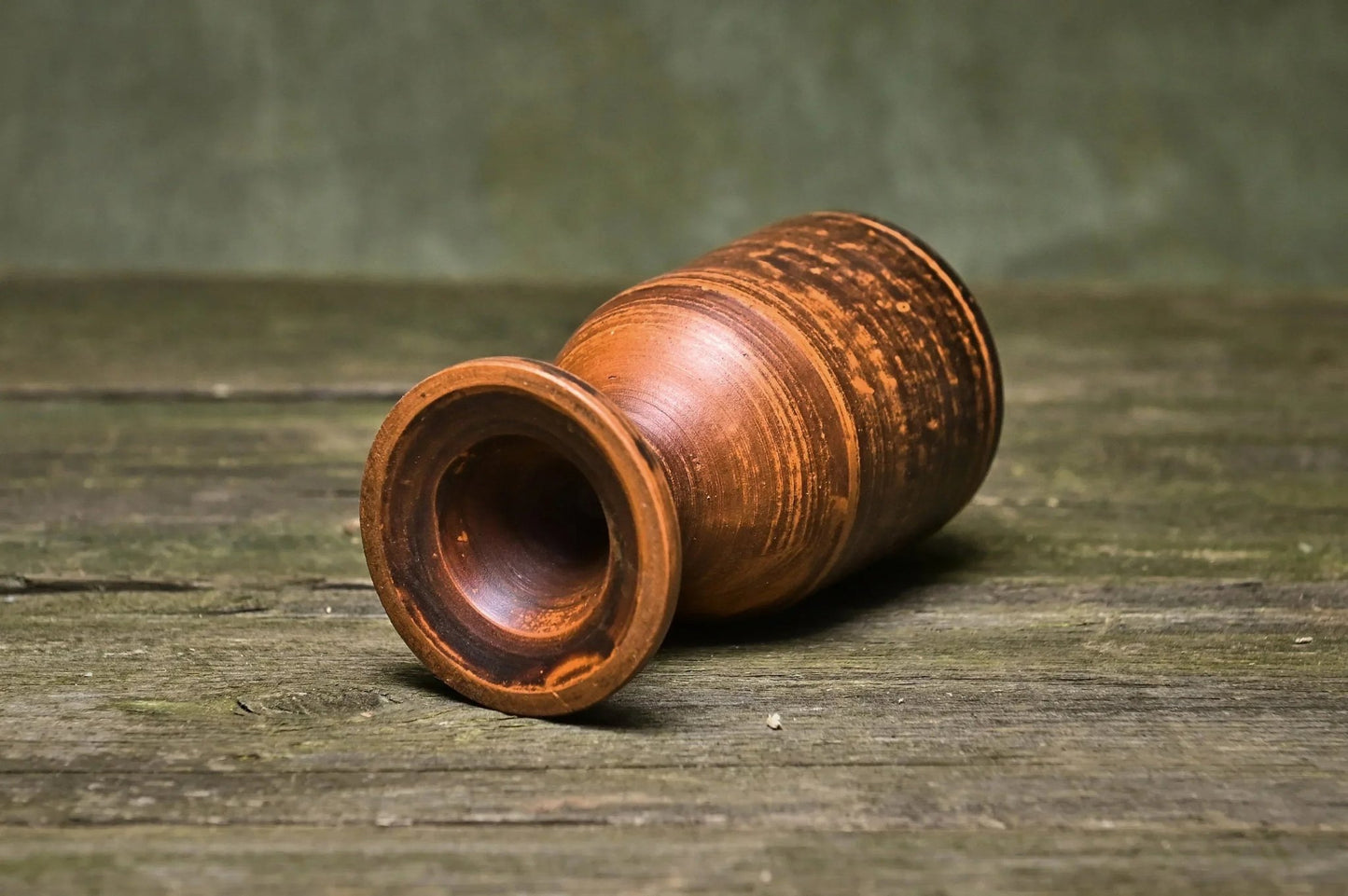 Handmade clay wine goblet with rustic finish on wooden surface, artisan pottery homeware