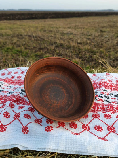 Handmade red clay bowl on embroidered cloth, rustic home decor from clayproductsshop