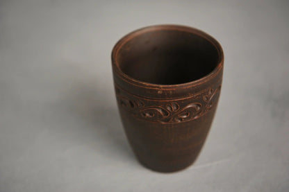 Hand-engraved red clay ceramic drinking glass with decorative pattern, artisan homeware