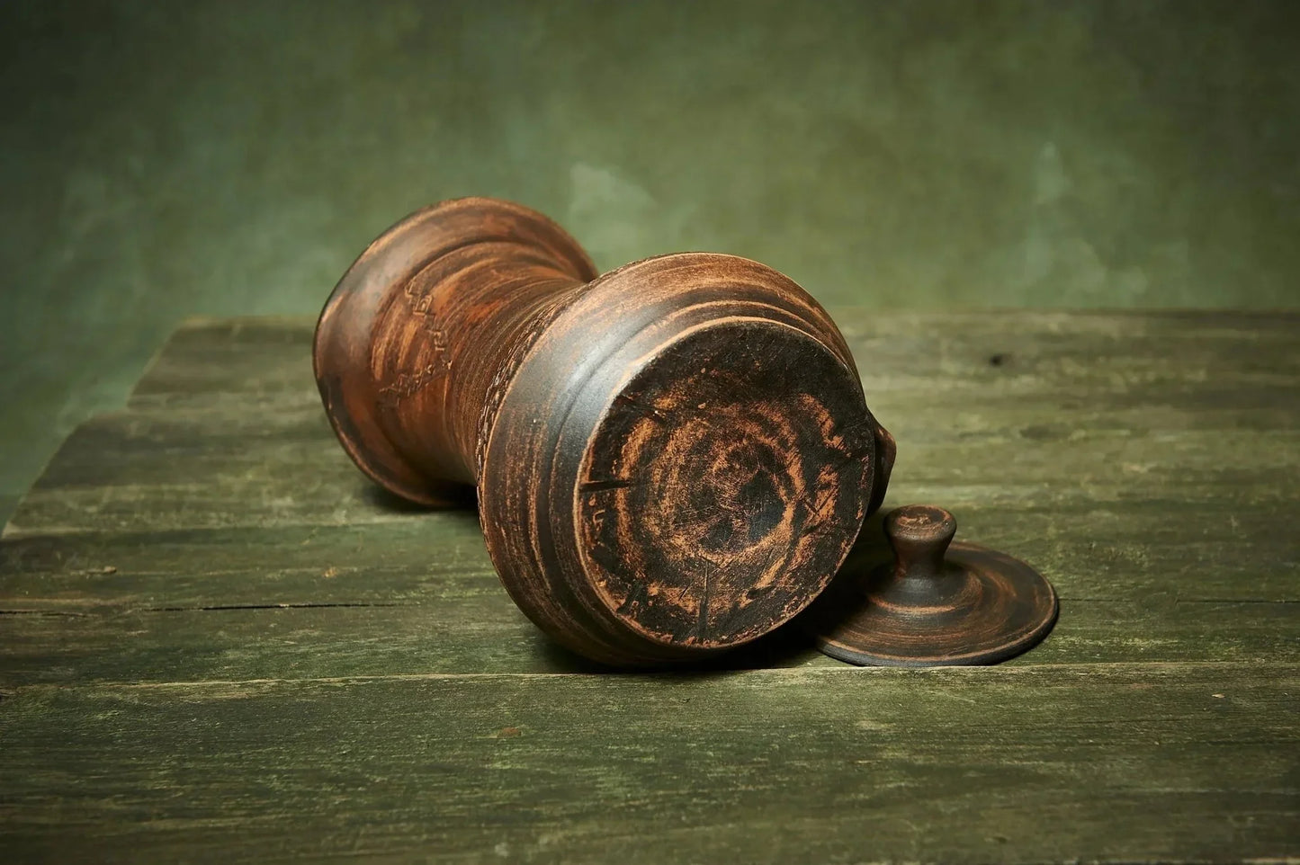 Handmade ceramic pitcher with lid on rustic wooden surface, artisan farmhouse clay homeware