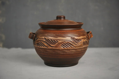 Handmade ceramic pot with lid, engraved design, artisanal clay cookware, two handles