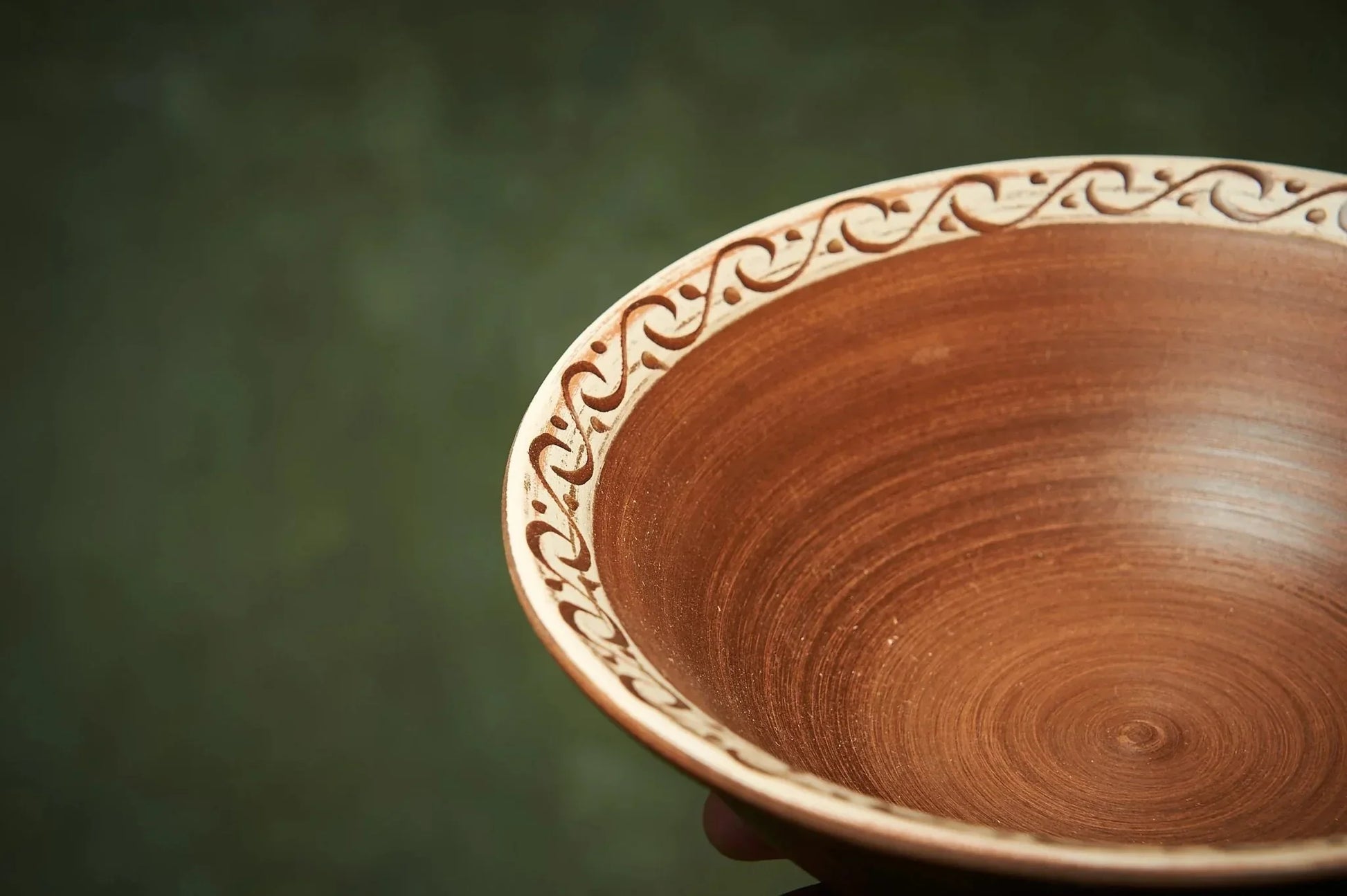 Handmade rustic clay bowl with hand-engraved swirl rim, artisan ceramic homeware