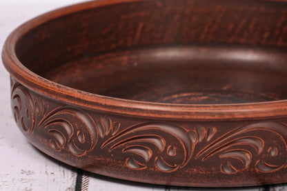 Handmade clay pancake maker plate with carved details, artisan ceramic kitchenware