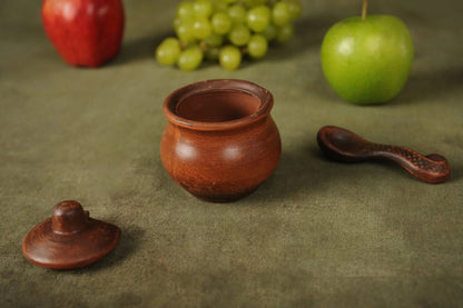 Handmade clay salt bowl with lid and spoon on green cloth, artisan homeware by clayproductsshop