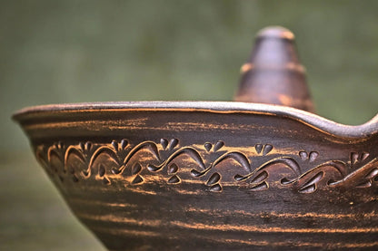 Handmade unglazed ceramic chicken roaster plate with carved pattern, artisan clay bakeware