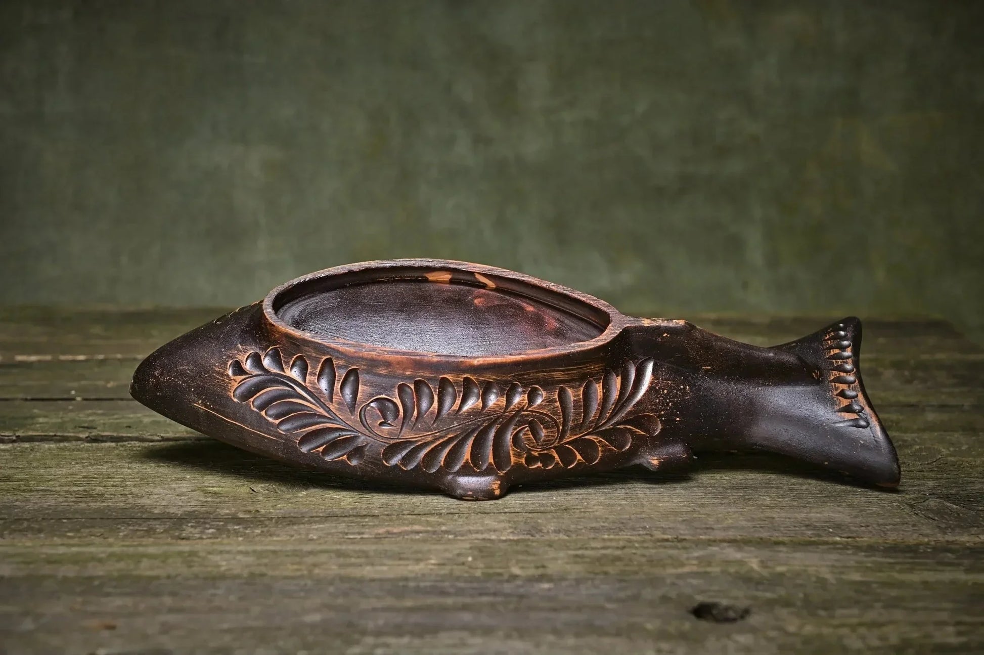 Handmade clay fish-shaped plate with carved leaf design, rustic pottery homeware