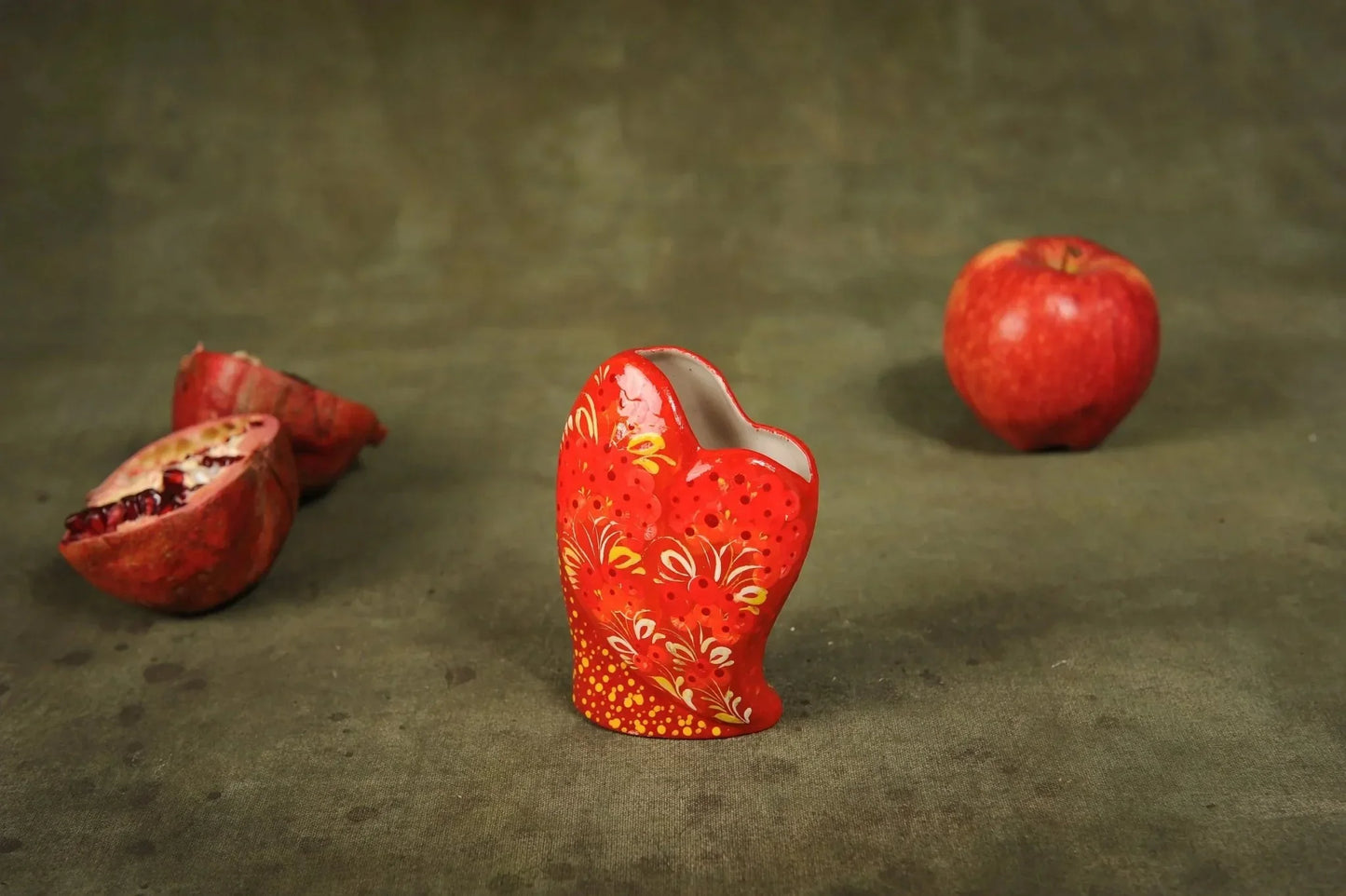 Hand-painted small ceramic heart-shaped vase with floral design, unique clay home decor on table