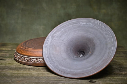 Handmade unglazed clay tagine pot with lid, rustic ceramic kitchenware on wood